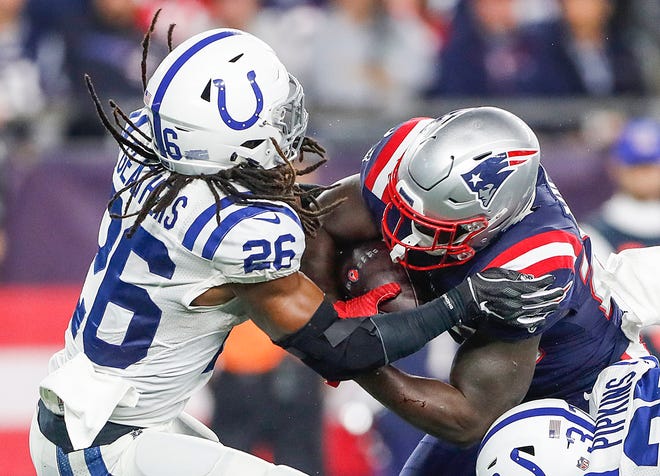 Indianapolis Colts defensive back Clayton Geathers (26) is shaken up by a hit from New England Patriots running back Sony Michel (26), sending Geathers to concussion protocol, in the second quarter at Gillette Stadium in Foxborough, Mass., Thursday, Oct. 4, 2018. 