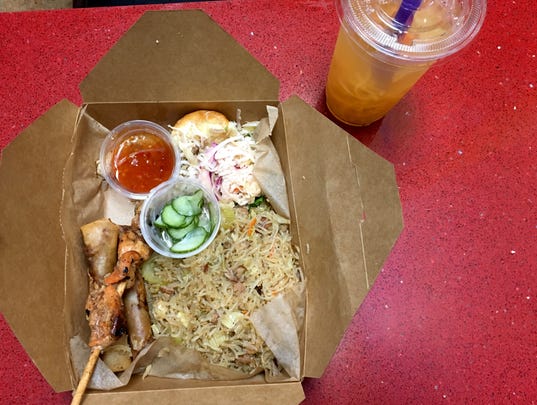 At Mestiza Kitchen, the MK combo, $10, includes Imperial Noodles, two lumpia, a chicken skewer and an adobo slider. Also pictured is cantaloupe juice, featuring shredded melon.