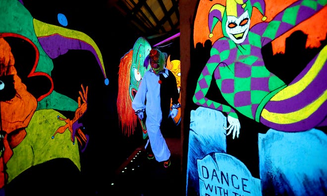 Sebastian Allen plays the part of a creepy clown at the Kitsap Haunted Fairgrounds on Friday, October 5, 2018.
