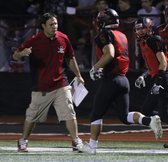 From 2018: Emerson coach Nick Calandrino congratulates running back Ryan Shaw after a touchdown in a game against Park Ridge last year.
