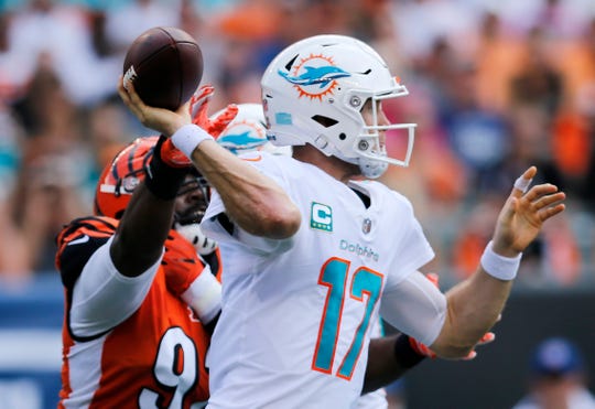 Cincinnati Bengals defensive tackle Adolphus Washington (92) reaches to disrupt a pass by Miami Dolphins quarterback Ryan Tannehill (17) in the second quarter of the NFL Week 5 game between the Cincinnati Bengals and the Miami Dolphins at Paul Brown Stadium in downtown Cincinnati on Sunday, Oct. 7, 2018. The Dolphins led 14-0 at halftime.