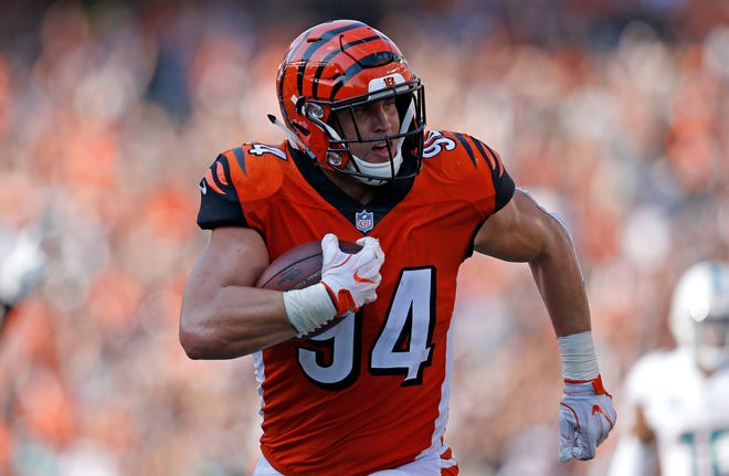 Cincinnati Bengals defensive end Sam Hubbard (94) runs back an interception for a touchdown in the fourth quarter of the NFL Week 5 game between the Cincinnati Bengals and the Miami Dolphins at Paul Brown Stadium in downtown Cincinnati on Sunday, Oct. 7, 2018. The Bengals overcame a 14-0 deficit to win 27-17.