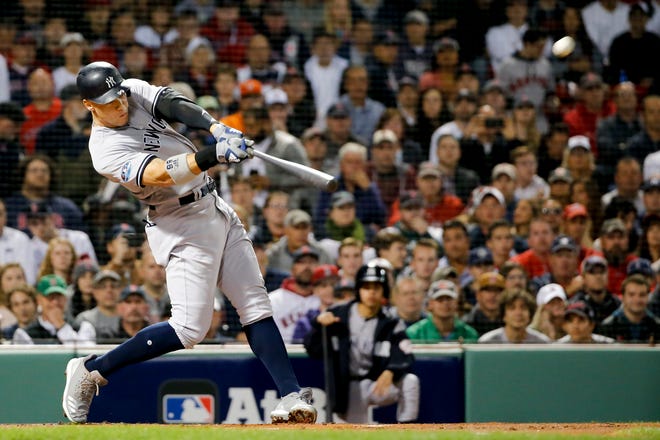 New York Yankees' Aaron Judge hits a home run against the Boston Red Sox during the first inning of Game 2 of a baseball American League Division Series, Saturday, Oct. 6, 2018, in Boston.