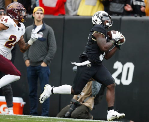Colorado wide receiver K.D. Nixon, right, pulls in a pass as Arizona State defensive back Chase Lucas pursues in the second half of an NCAA college football game Saturday, Oct. 6, 2018, in Boulder, Colo. Colorado won 28-21. (AP Photo/David Zalubowski)