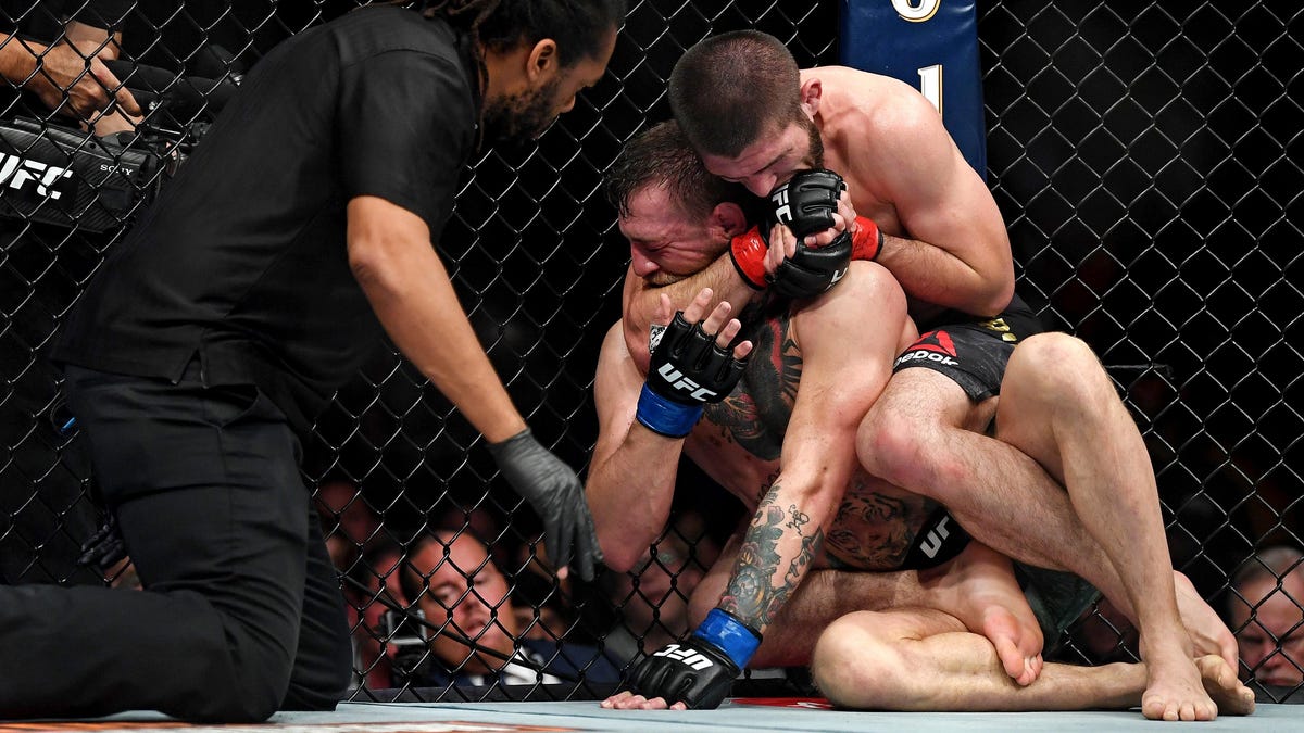 Khabib Nurmagomedov slips the winning choke hold on Conor McGregor.