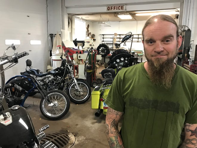 Kai Morrison stands for a portrait in his business Kai's Kustoms, which moved in August to the old Buck's Muffler location on Cliff Avenue.