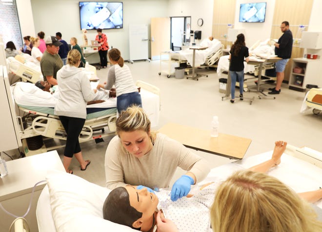 Kaysea Sonterre practices a procedure in Ohio University Zanesville’s new nursing lab.