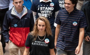 Supporters of Supreme Court nominee Brett Kavanaugh walk through the Hart Senate Office Building as the Senate Judiciary Committee hears from Kavanaugh and Christine Blasey Ford on Capitol Hill in Washington, Sept. 27, 2018.