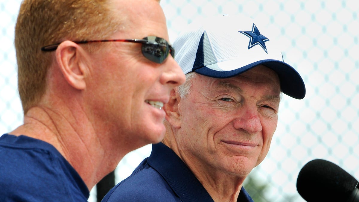 Dallas Cowboy owner Jerry Jones, right, looks on as head coach Jason Garrett, left, answers a question from the press.