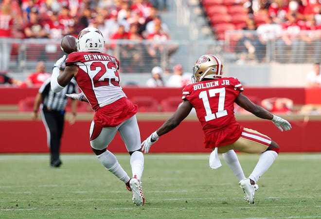 Arizona Cardinals defensive back Bene' Benwikere (23) intercepts a pass in front of San Francisco 49ers wide receiver Victor Bolden Jr. (17) during the second half of an NFL football game in Santa Clara, Calif., Sunday, Oct. 7, 2018.