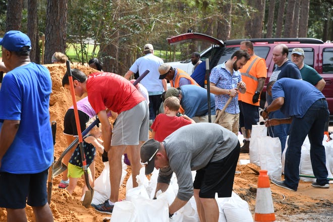 Tallahassee community members come together at Winthrop Park to make sandbags in preparation for Hurricane Michael on Tuesday, Oct. 9, 2018.