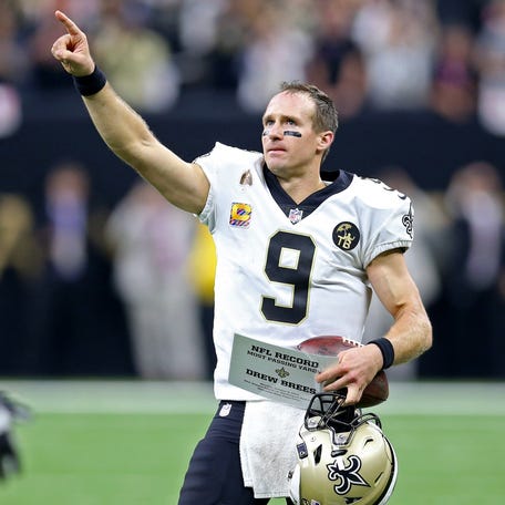 Drew Brees acknowledges the crowd after setting the NFL's all-time career passing yardage mark against the Washington Redskins in the second quarter at the Mercedes-Benz Superdome.