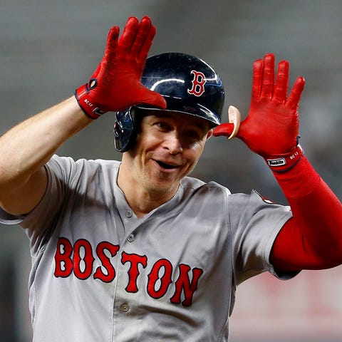 Brock Holt celebrates his two-run home run in the...