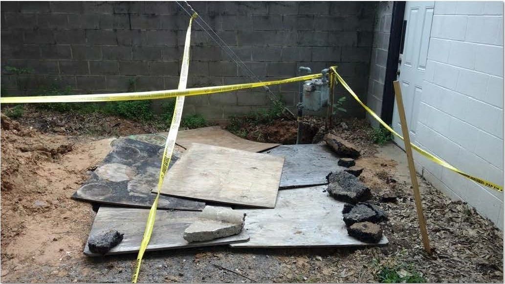 An exhibit filed in the Williams family's lawsuit against Centerpoint Energy shows a gas line repair covered with plywood and chunks of asphalt.