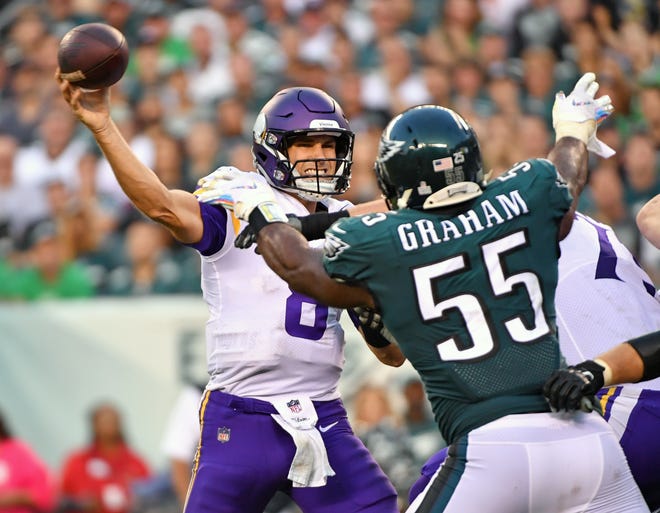 Minnesota Vikings quarterback Kirk Cousins (8) throws a pass under pressure from Philadelphia Eagles defensive end Brandon Graham (55) during the third quarter at Lincoln Financial Field.