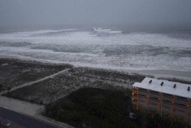 Water reaches the dunes on Pensacola Beach early Wednesday morning as Hurricane Michael approaches.