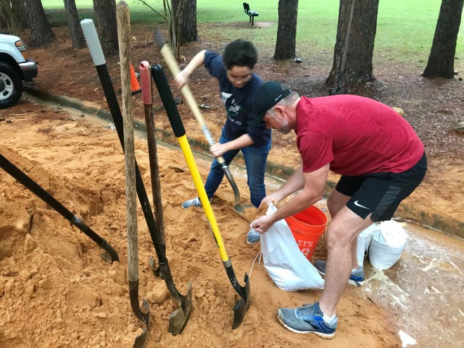 Residents fill sandbags at Winthrop Park during an earlier storm. During Saturday's heavy rains, the city opened a sandbag site at James Messer Park South, located at 2830 Jackson Bluff Road, on the south side of Jackson Bluff Road.