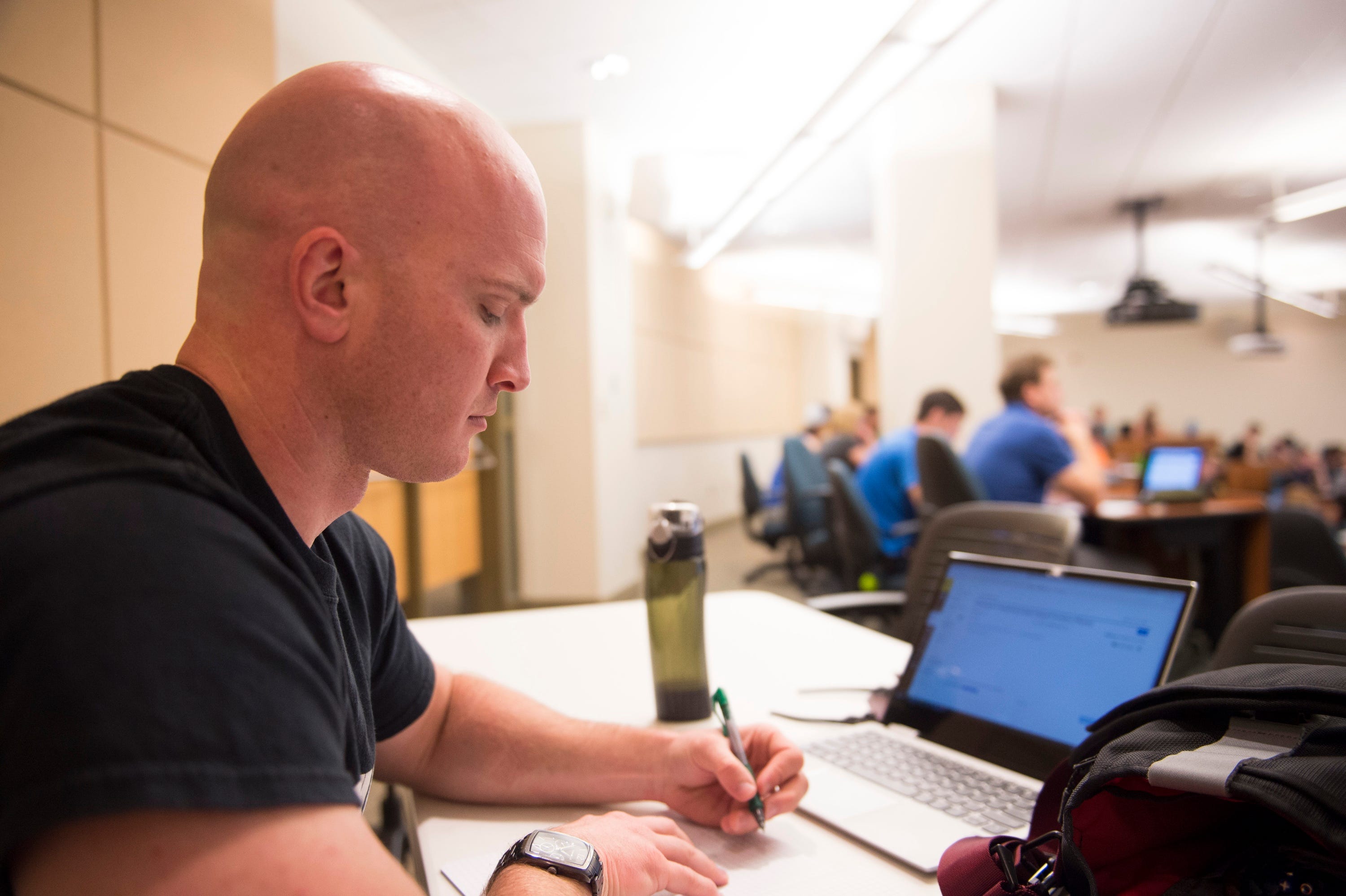 Halston Drennan takes notes during his calculus III course at the University of Wyoming. Drennan used to teach high school math in Fort Collins, Colo., but decided to go back to college to get another bachelor's degree, this time in chemical engineering. He says his teaching salary, even augmented by a second job, would never have allowed him to buy a home.