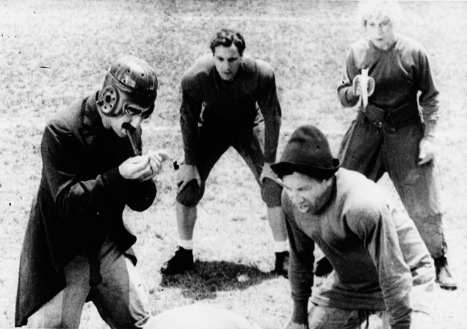 College professor Quincy Adams Wagstaff (Groucho Marx, left) gets ready for a play with his football team (including Zeppo Marx, Chico Marx and Harpo Marx) in the big game against a rival school in "Horse Feathers."
