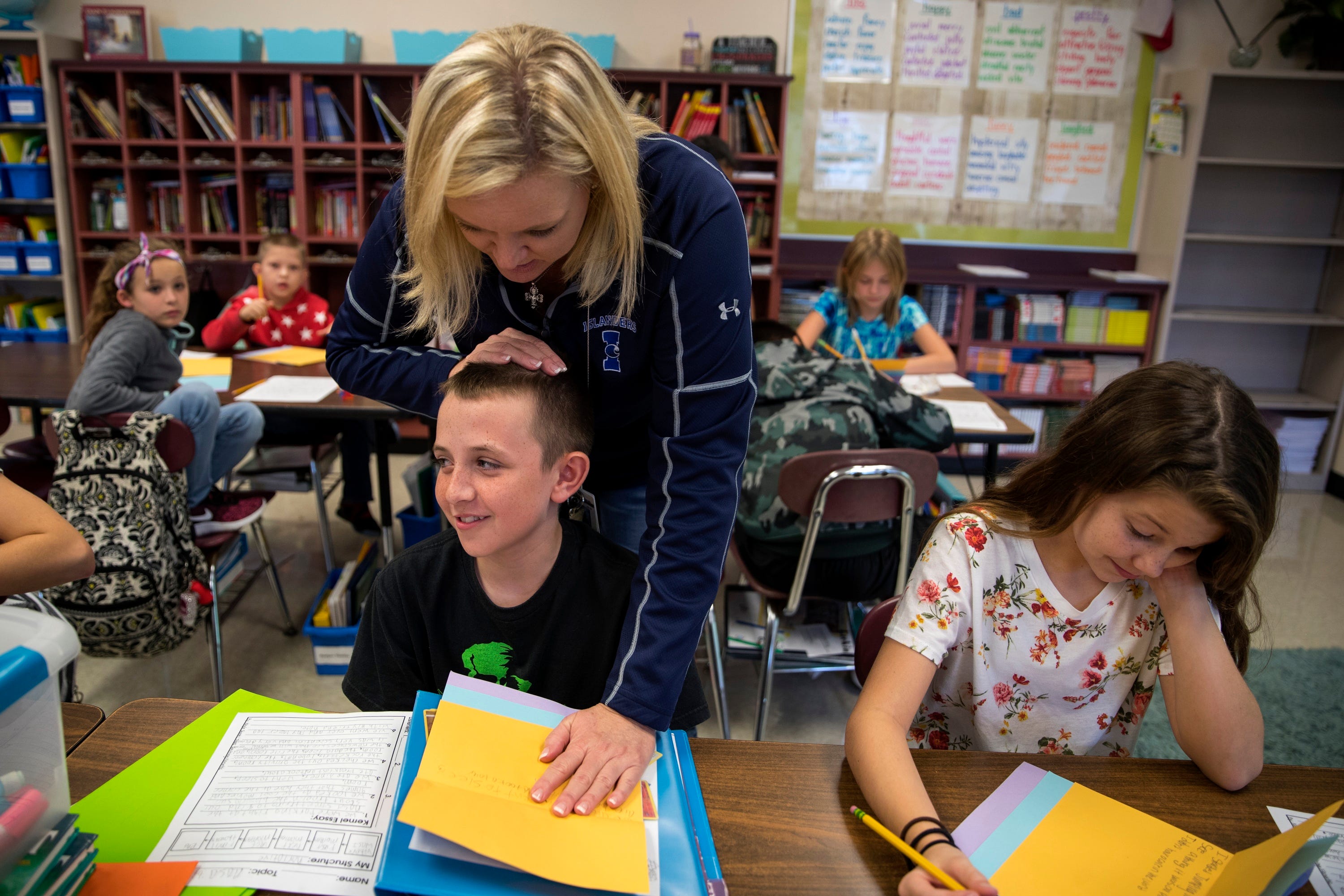 Christine McFarland, a fifth-grade teacher at Sinton Elementary School in Sinton, Texas, encourages students during a writing project. "In the morning I get up with hopes of making a difference in the lives of a child," she says, despite knowing that "they don't want to be at school, most of them." But, she says, "I want them to know they have a safe place to go with someone who cares about them and wants them to learn."