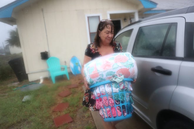 PANAMA CITY, FL - OCTOBER 10:  Kathy Eaton takes what she can from her home as she tries to get out of the way of the storm as the outerbands of  hurricane Michael arrive on October 10, 2018 in Panama City Beach, Florida. The hurricane is forecast to hit the Florida Panhandle at a possible category 4 storm.  (Photo by Joe Raedle/Getty Images) ORG XMIT: 775240672 ORIG FILE ID: 1048869042