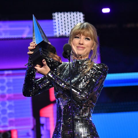 Taylor Swift accepts Artist of the Year onstage...