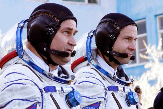 U.S. astronaut Nick Hague, right and Russian cosmonaut Alexey Ovchinin, member of the main crew of the expedition to the International Space Station (ISS), walk prior to the launch of Soyuz MS-10 space ship at the Russian leased Baikonur cosmodrome, Kazakhstan, Thursday, Oct. 11, 2018. (AP Photo/Dmitri Lovetsky, Pool)