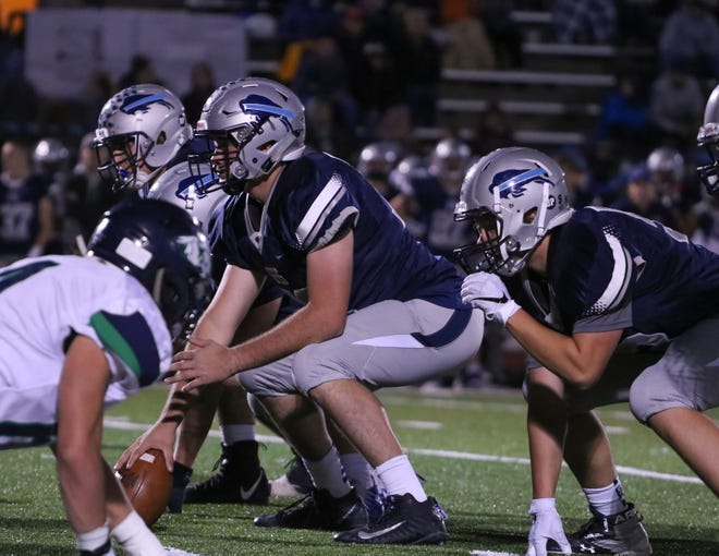 Sophomore Hayden Johnson (center, snapping football) is a key performer for the Great Falls High offensive line.