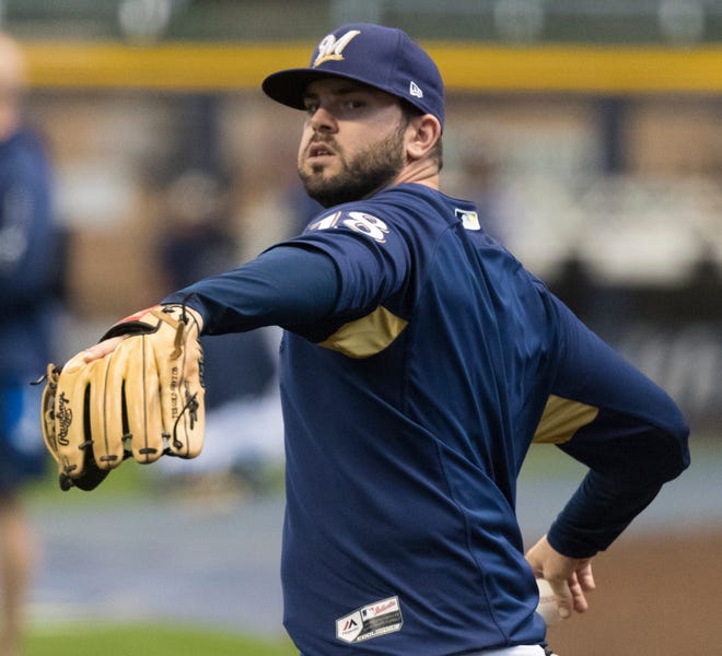 Brewers third baseman Mike Moustakas practices Thursday at Miller Park a day before Game 1 of the NLCS against the Dodgers.