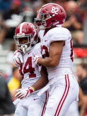 Alabama running back Damien Harris (34) and tight end Irv Smith Jr. (82) celebrate Harris' touchdown against Arkansas during first half action in Fayetteville, Ark., on Saturday October 6, 2018.