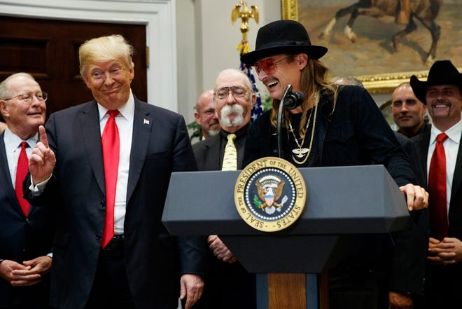 President Donald Trump gestures as musician Kid Rock speaks during a signing ceremony for the Orrin G. Hatch-Bob Goodlatte Music Modernization Act in the Roosevelt Room of the White House on Thursday, Oct. 11, 2018.
