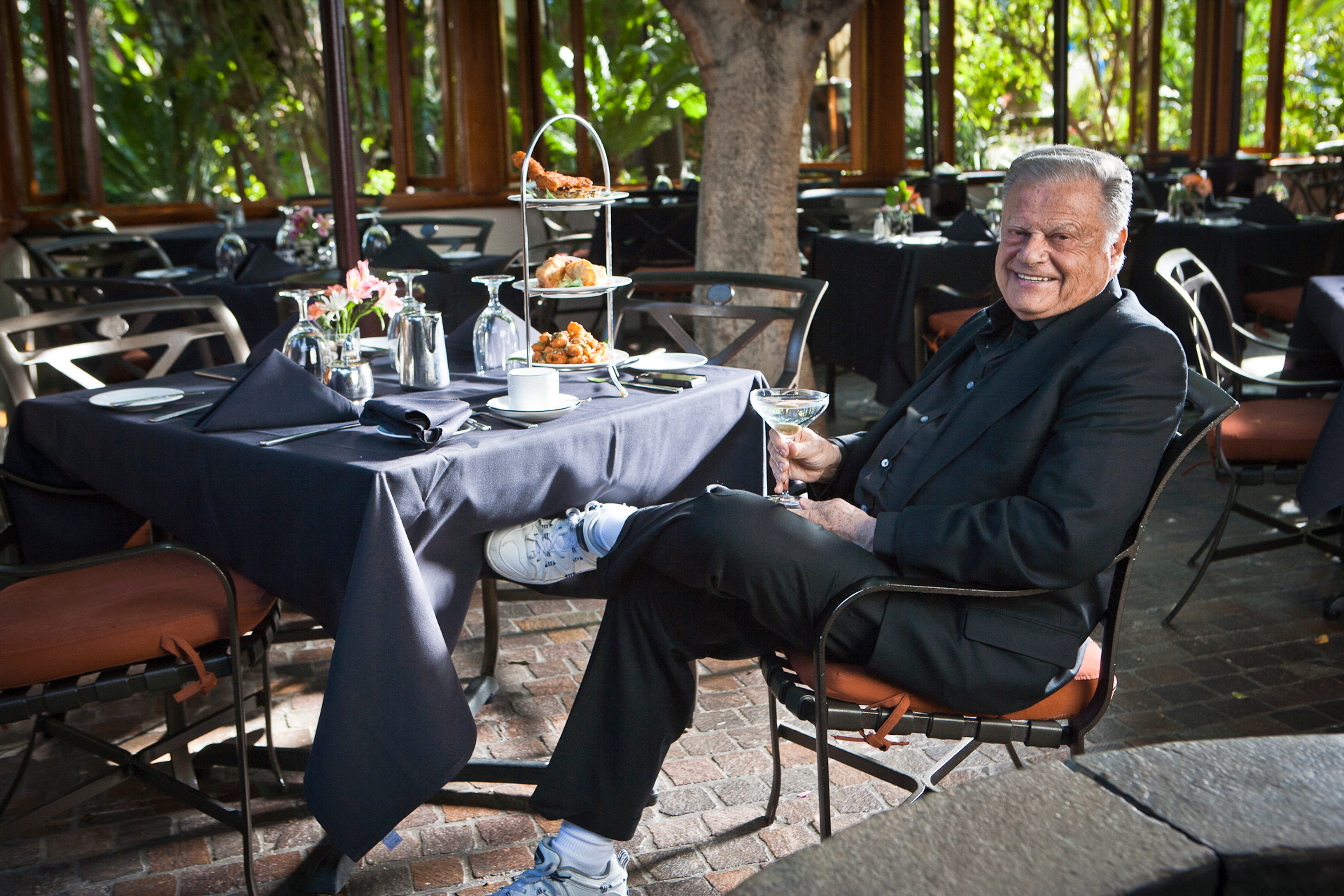 Harold Matzner, philanthropist and owner of Spencer’s Restaurant, enjoying a cocktail on the patio.