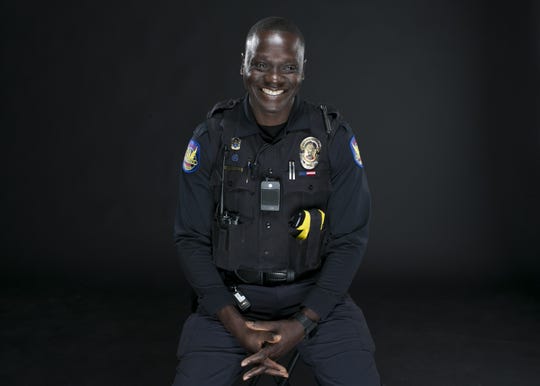 Phoenix police officer Germain Dosseh sits in the studio at the Arizona Republic in Phoenix on Wed. Sep. 12, 2018. Dosseh fled Togo, Africa to become a refugee in the United States, where he would later serve in the U.S. army in Afghanistan before coming to Phoenix and joining the police force.