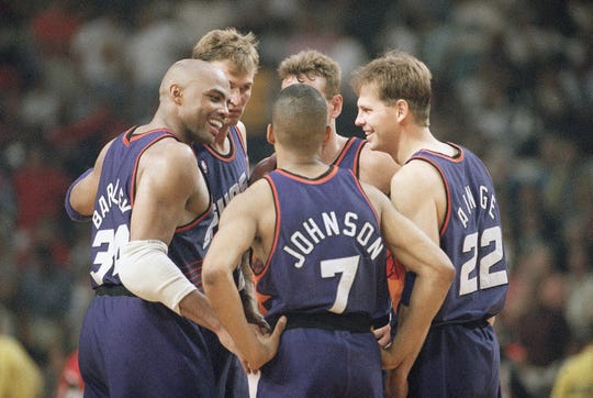 Suns players Charles Barkley (left), Kevin Johnson, and Danny Ainge are all smiles as they confer late in the triple-overtime period of their 129-121 win over the Chicago Bulls on June 13, 1993, in Chicago. Also in on the celebration are Tom Chambers, rear left, and Dan Majerle.