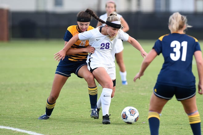 Hardin-Simmons midfielder Kenne Kessler (28) gets away from the grasp of Howard Payne's Leah Gordish (28) at the HSU Soccer Complex on Thursday, Oct. 11, 2018. The Cowgirls won 4-1.