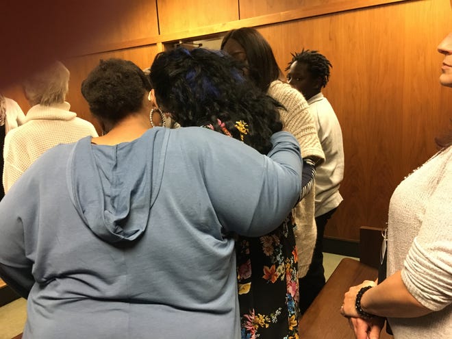 Brennan Walker's mother Lisa Wright, center in black dress, is comforted Friday in Oakland County Circuit Court after Jeffrey Zeigler was found guilty of an assault charge for firing a shotgun at her teenage son.