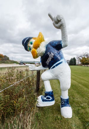 Traffic on I-94 streams past a statue of Bernie Brewer outside the offices of Clear Channel Outdoor in Pewaukee on Friday, Oct. 12. The company temporarily placed the statue along their fence line to welcome Milwaukee Brewers fans headed to Friday's game.