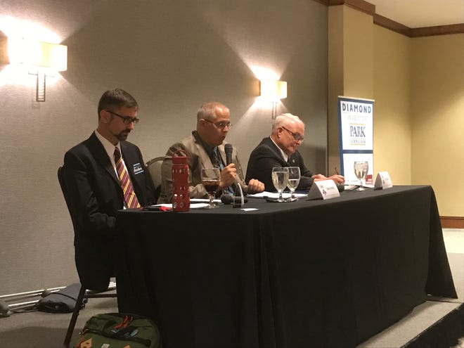 Commissioner Rick Black, right, and challenger Adam Rhodes, left, listen to moderator Dave Doney at the Licking County Chamber debate on Oct. 11, 2018.