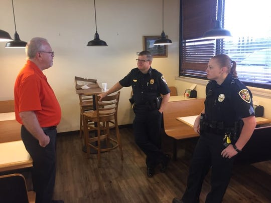 (From left)-Ron Sponagel, manager of Fenn's Country Market in Artesia visits with Artesia Police Chief Kirk Roberts and Artesia Police Sgt. Chantel Longway Friday during Coffee and Donuts with a Cop. Roberts said the Artesia Police Department likes to go to different places monthly to meet with the community.