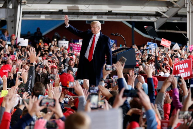 President Donald Trump takes the state as he's introduced during a Make America Great Again rally at the warren County Fair Grounds in Lebanon, Ohio, on Friday, Oct. 12, 2018.