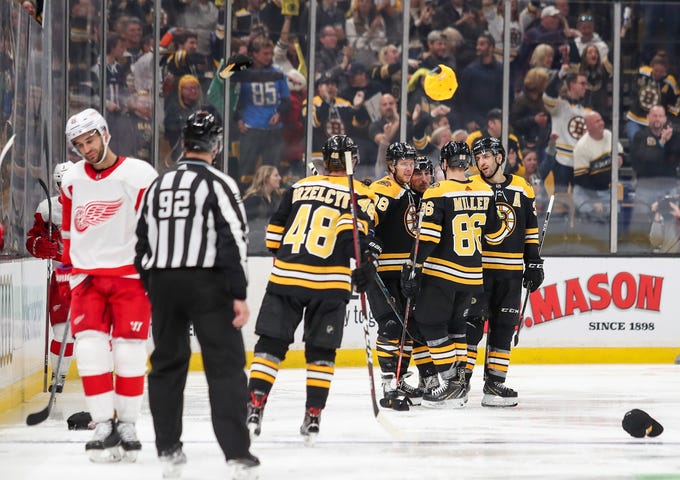 Bruins celebrate after left wing David Pastrnak scores his third goal during the third period of the Wings' 8-2 loss on Saturday, Oct. 13, 2018, in Boston.