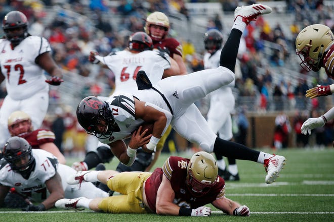 Boston College linebacker Connor Strachan, bottom, stops Louisville running back Trey Smith (12) short of the goal line during the first half of an NCAA college football game in Boston, Saturday, Oct. 13, 2018.