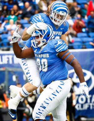 Memphis defender John Tate IV (bottom) celebrates his second sack with teammate Jonathan Wilson (top)Central Florida during action in Memphis, Tenn., Saturday, October 13, 2018.
