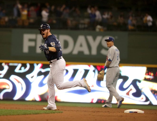 A pumped up Brandon Woodruff of the Brewers makes his tour of the bases after hitting a solo homer against the Dodgers in Game 1 of the NLCS on Friday night at Miller Park.
