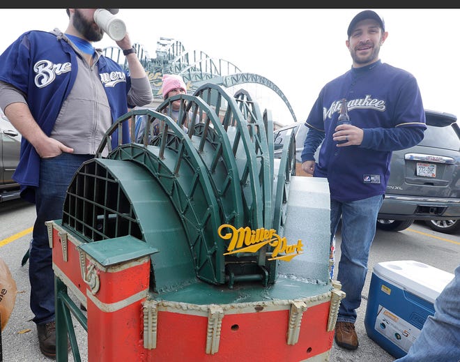 Dylan Brown (left), Brittany Brown, Josh Jenswold, Evan Olson, enjoy a brew with a  steel replica of Miller Park made 3 years ago by their friend  Matt Tyler who used to live in Brown Deer and tinkered in metal work.