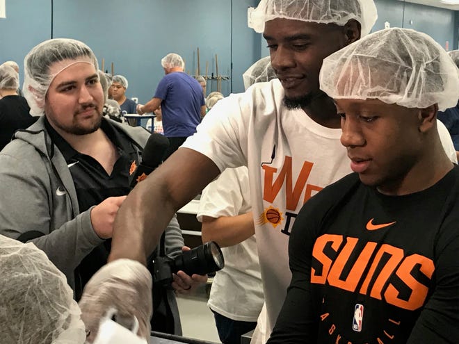 Phoenix Suns Josh Jackson and Isaiah Canaan pictured preparing packed meals at Feed My Starving Children event Friday evening.