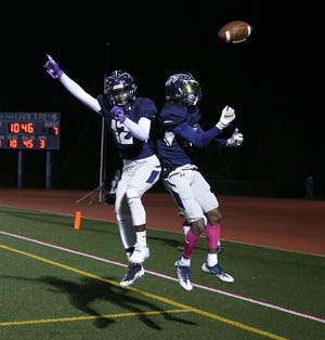 Eastridge's Jalen Rose Hannah (12) celebrates with Tony Arnold after Arnold's 45-yard touchdown reception early in the third quarter of the Lancers' win over Greece Arcadia.