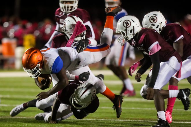 Millville's Tex Thompson gets upended by Bridgeton's Shamir Love during Friday night's football game played at Bridgeton High School on October 12, 2018.