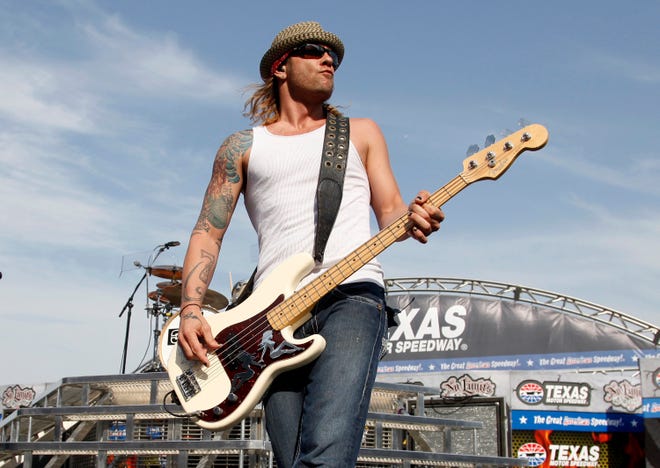In this April 9, 2011 file photo, 3 Doors Down' bassist Todd Harrell performs before a NASCAR auto race at Texas Motor Speedway in Fort Worth, Texas.