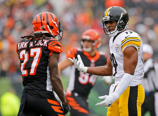 Cincinnati Bengals cornerback Dre Kirkpatrick (27) and Pittsburgh Steelers wide receiver JuJu Smith-Schuster (19) exchange shoves after a play in the first quarter of the NFL Week 6 game between the Cincinnati Bengals and the Pittsburgh Steelers at Paul Brown Stadium in downtown Cincinnati on Sunday, Oct. 14, 2018. The game was tied 14-14 at half time.